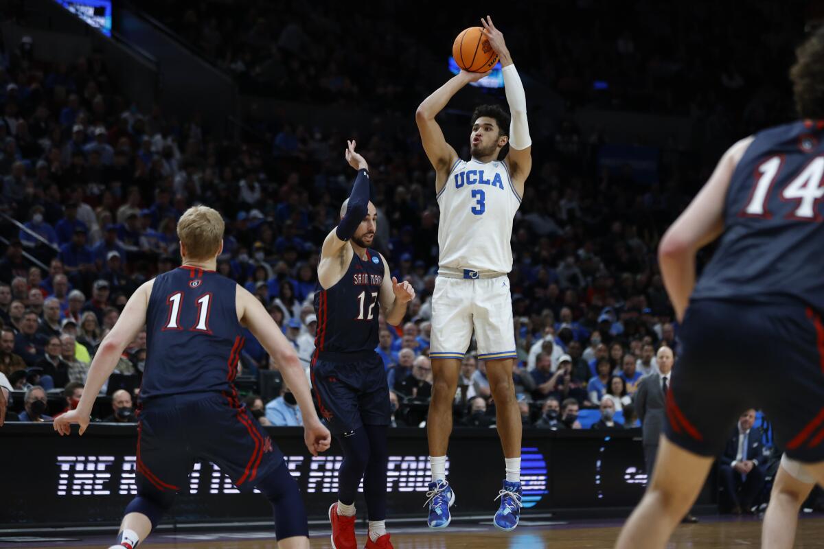 UCLA guard guard Johnny Juzang shoots above St. Mary's guard Tommy Kuhse.