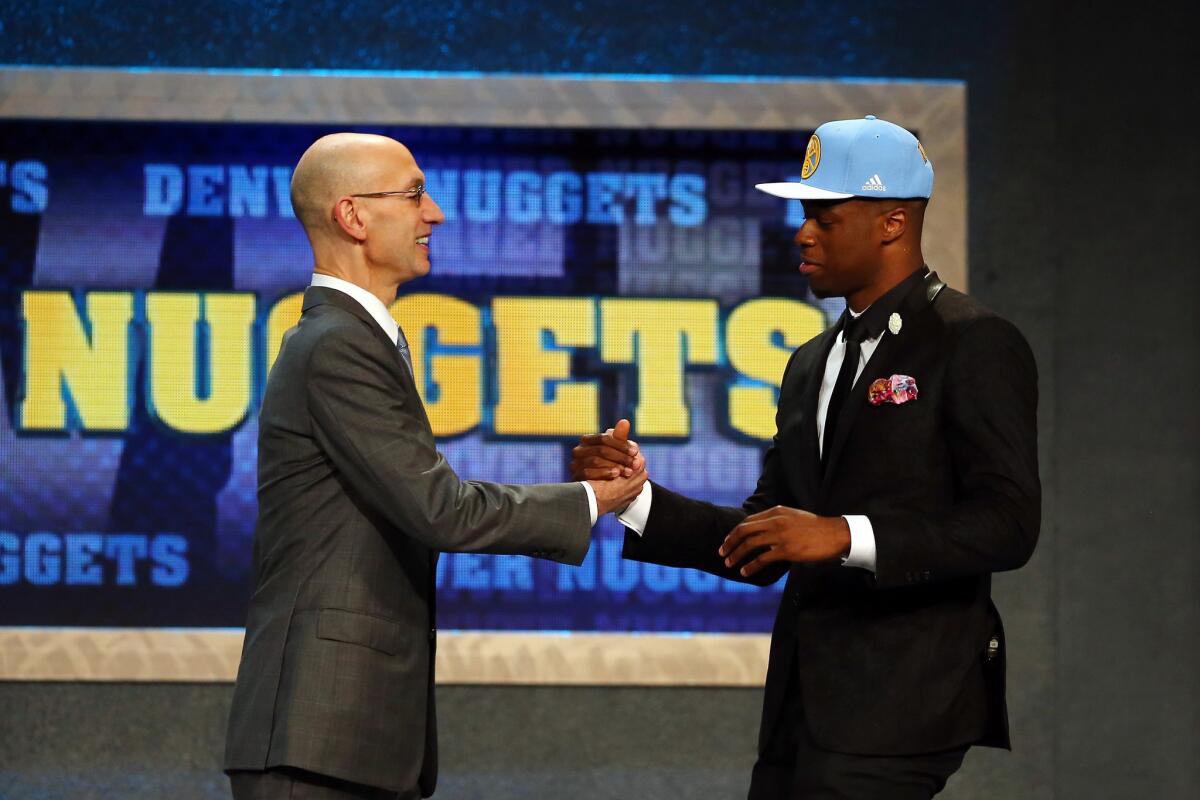 Emmanuel Mudiay meets NBA Commissioner Adam Silver after being drafted by the Denver Nuggets at the NBA draft at Barclays Center in Brooklyn, N.Y., on June 25.