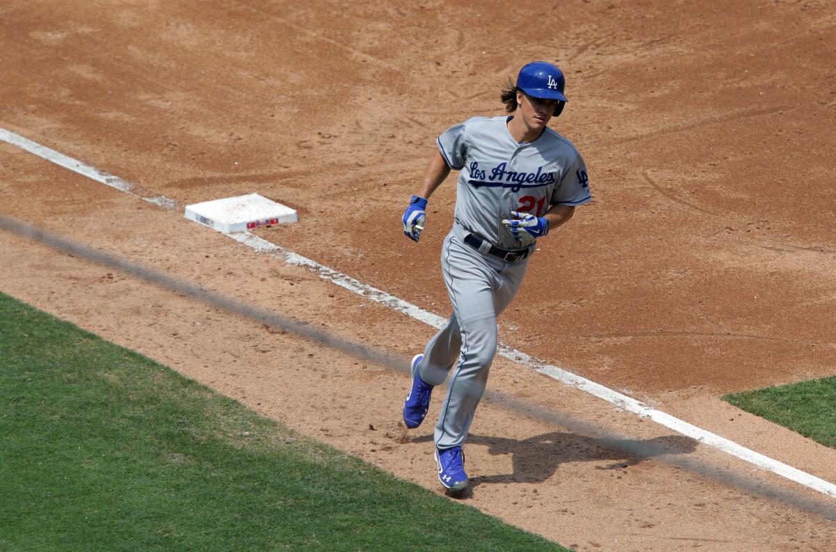 Dodgers starting pitcher Zack Greinke rounds third base after hitting a home run against the Phillies. Greinke was 3 for 3 on the day.