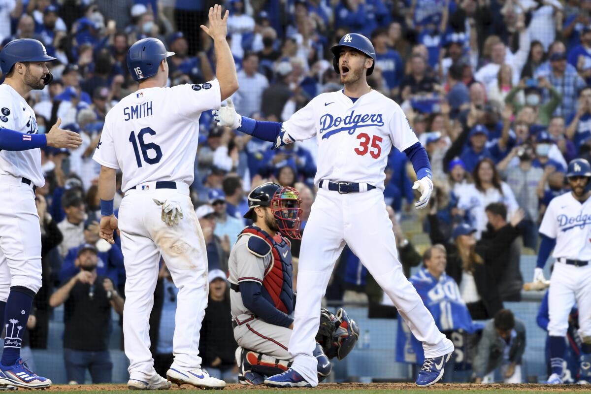 Dodgers' Cody Bellinger, right, celebrates with Will Smith and AJ Pollock.