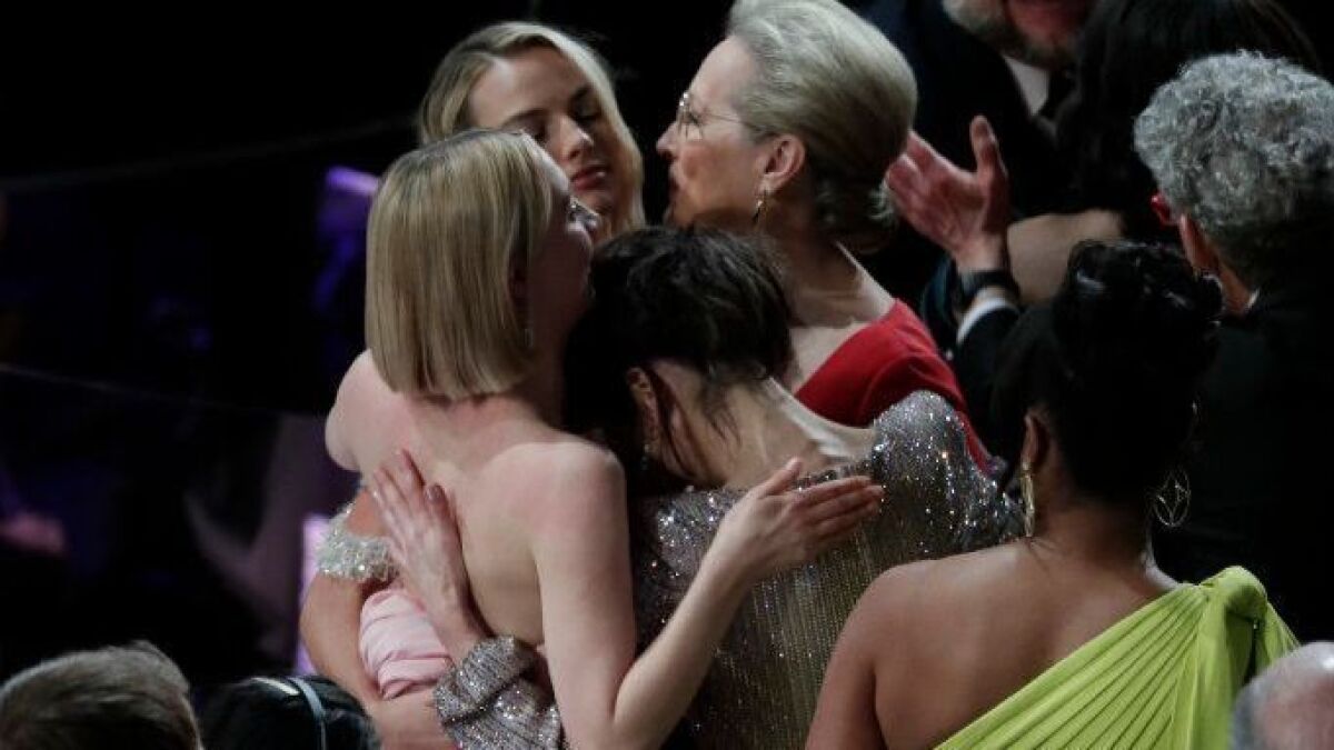 Lead actress contenders Saoirse Ronan, Margot Robbie, Meryl Streep and Sally Hawkins, clockwise starting left, embrace after Frances McDormand's win at the 90th Academy Awards.