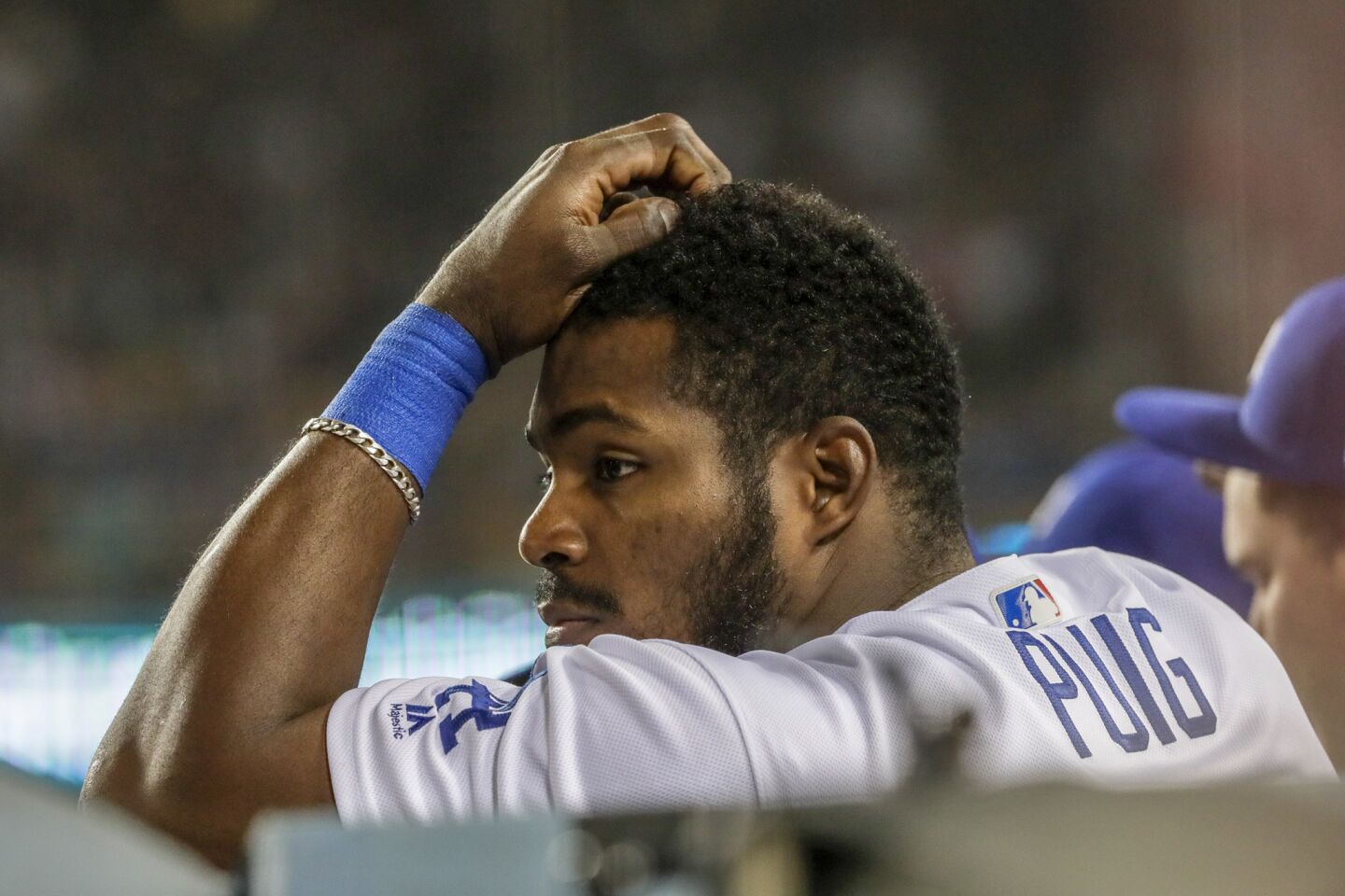 Dodgers' Yasiel Puig looks on from the bench as the Red Sox carry a 5-1 lead late in Game 5.