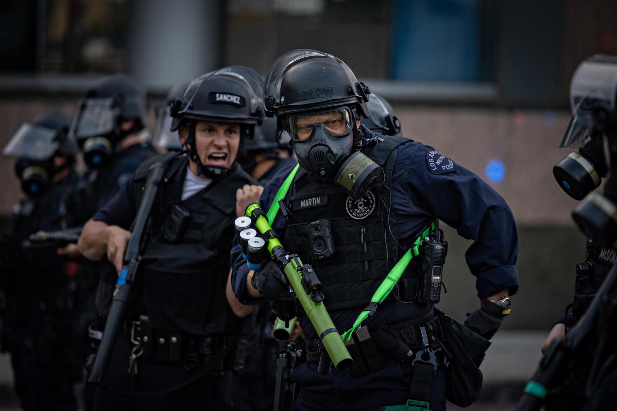 L.A. police clear the street outside the Metropolitan Detention Center on Friday.
