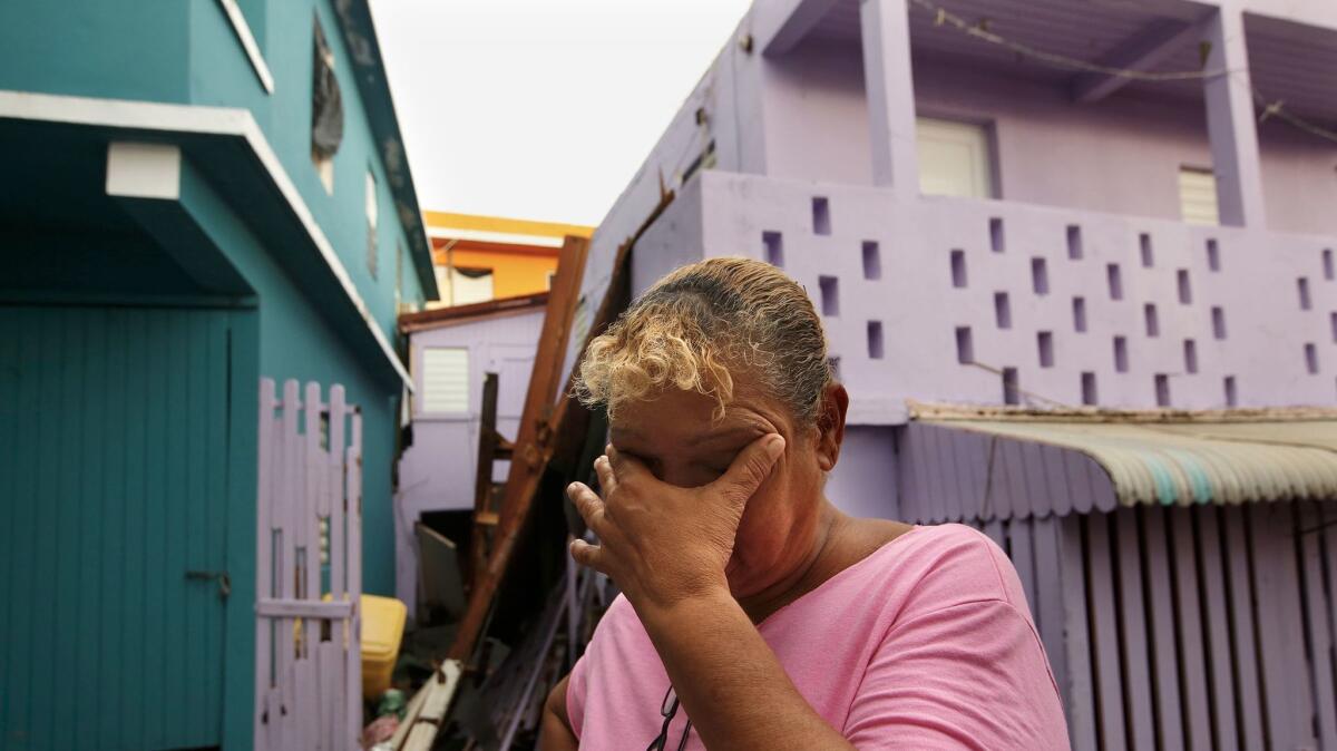 Sonia Viruet, 61, who lives in the La Perla neighborhood, takes stock after Hurricane Maria caused widespread damage across Puerto Rico. (Carolyn Cole / Los Angeles Times)
