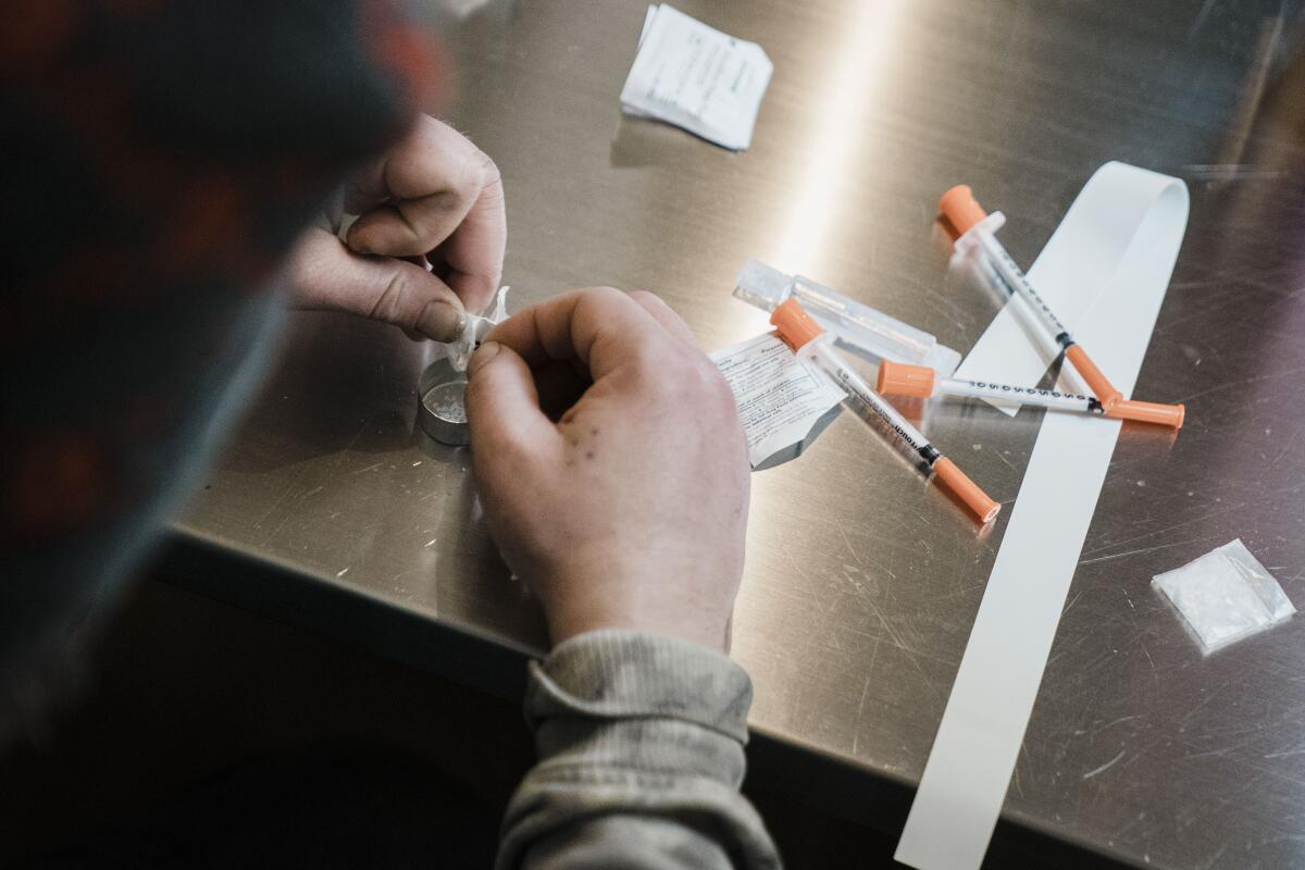 A man utilizes the narcotic consumption booths at a safe injection site 