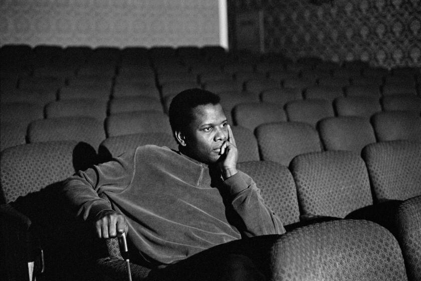A man sits alone in an empty theater.