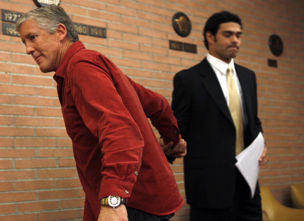 Then-USC coach Pete Carroll, left, shakes hands with quarterback Mark Sanchez after the quarterback announced his decision to turn pro in January 2008.