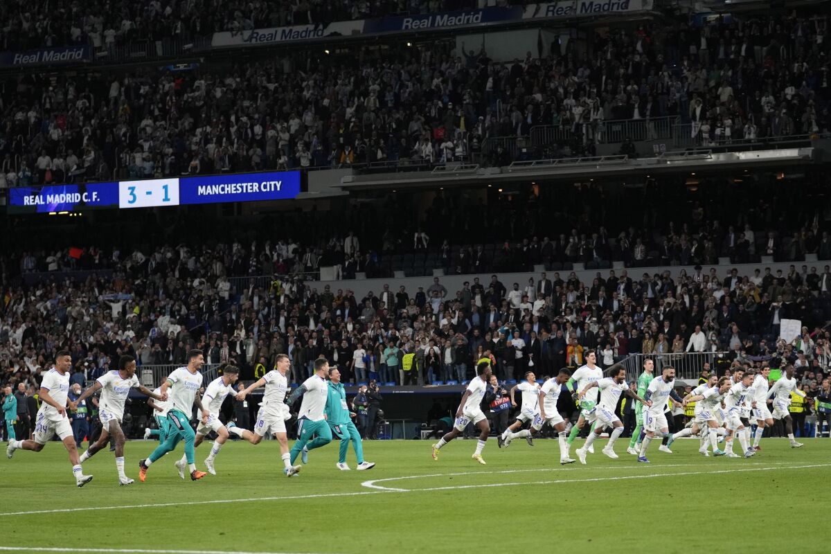 Real Madrid players celebrate after the Champions League semi final, second leg, soccer match between Real Madrid and Manchester City at the Santiago Bernabeu stadium in Madrid, Spain, Wednesday, May 4, 2022. Real won 3-1. (AP Photo/Bernat Armangue)