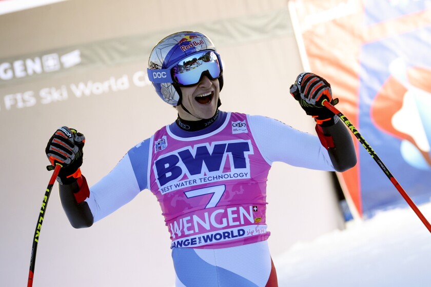 Switzerland's Marco Odermatt celebrates at the finish area of an alpine ski, men's World Cup super G, in Wengen, Switzerland, Thursday, Jan. 13, 2022. (AP Photo/Luciano Bisi)
