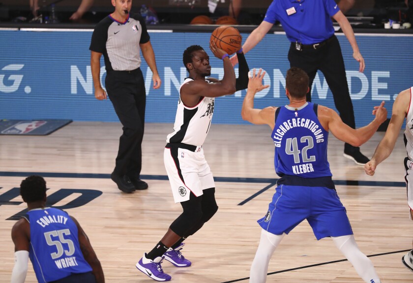 Clippers guard Reggie Jackson shoots a three-pointer over Dallas Mavericks forward Maxi Kleber.