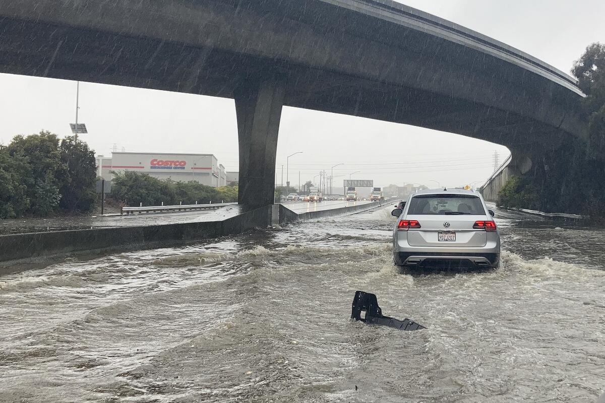 A car driving on a flooded freeway in the rain