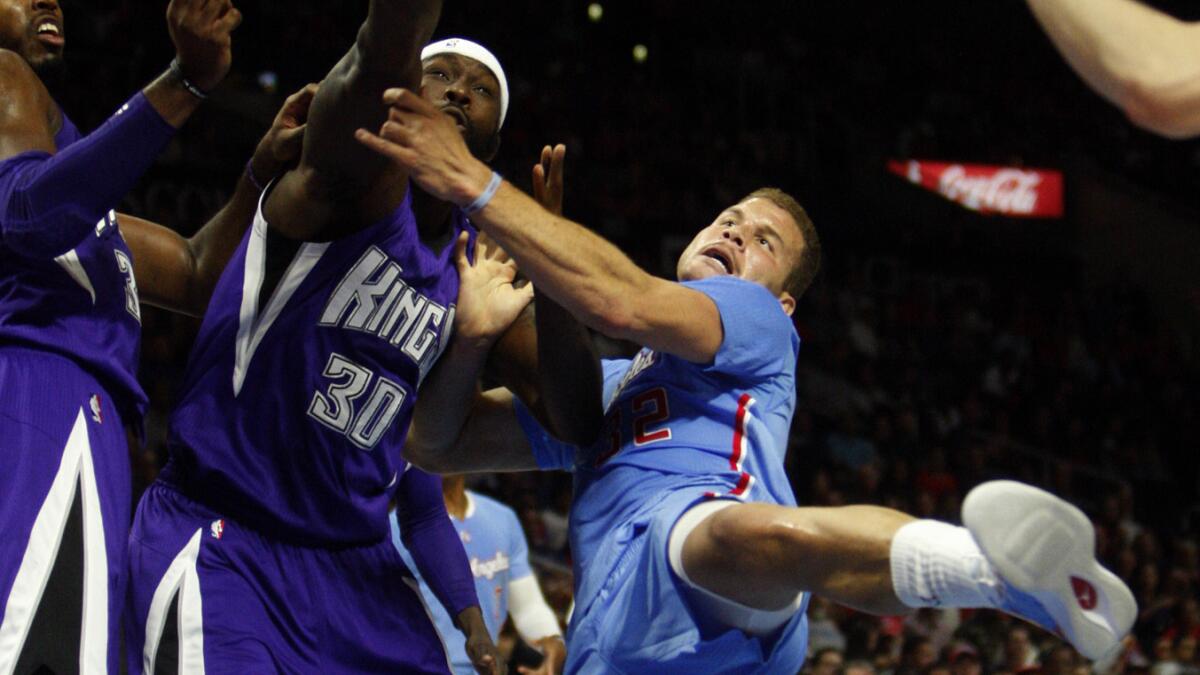 Sacramento Kings forward Reggie Evans, left, blocks a shot by Clippers forward Blake Griffin during the first half of the Clippers' 98-92 loss at Staples Center on Nov. 2.