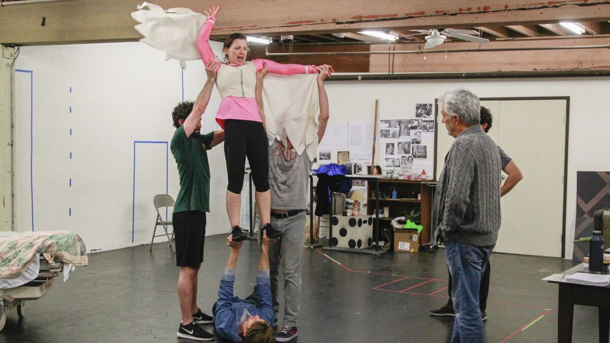 Debra Wanger, who plays the Angel, rehearses a scene from Cygnet Theatre's "Angels in America" with cast mates and director Sean Murray (left).