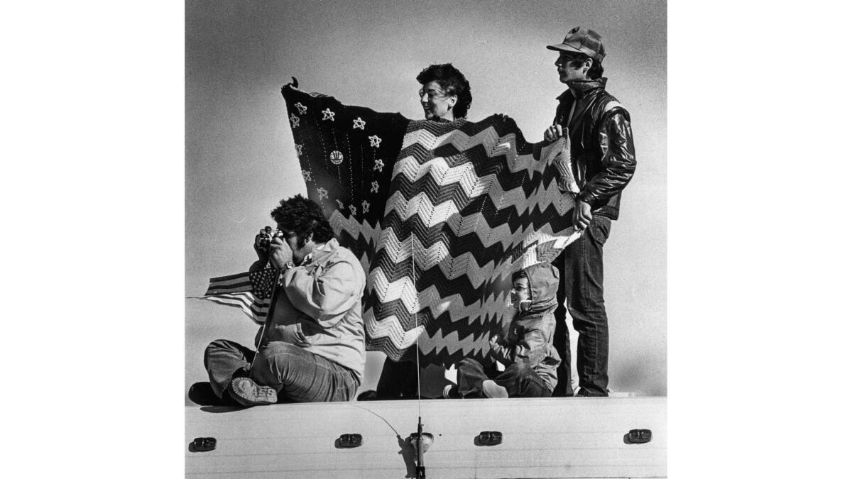 Nov. 14, 1981: Perched atop motorhome to view landing of Columbia are Lorraine Rios, holding afghan, brother Mike Buscemi and her son Jason, 9. Another brother, Norm Buscemi, takes photos. The afghan was made by Rios' mother.