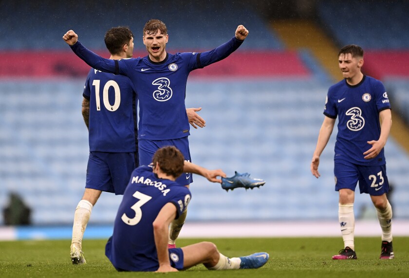 Chelsea's Timo Werner, centre, and Chelsea's Marcos Alonso, front, celebrate after winning the English Premier League soccer match between Manchester City and Chelsea at the Etihad Stadium in Manchester, Saturday, May 8, 2021.(Laurence Griffiths/Pool via AP)