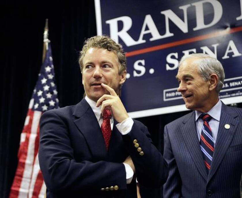 Sen. Rand Paul (R-Ky.), left, with his father, Rep. Ron Paul (R-Texas). A study found the younger Paul's oratory to be at an eighth-grade level.