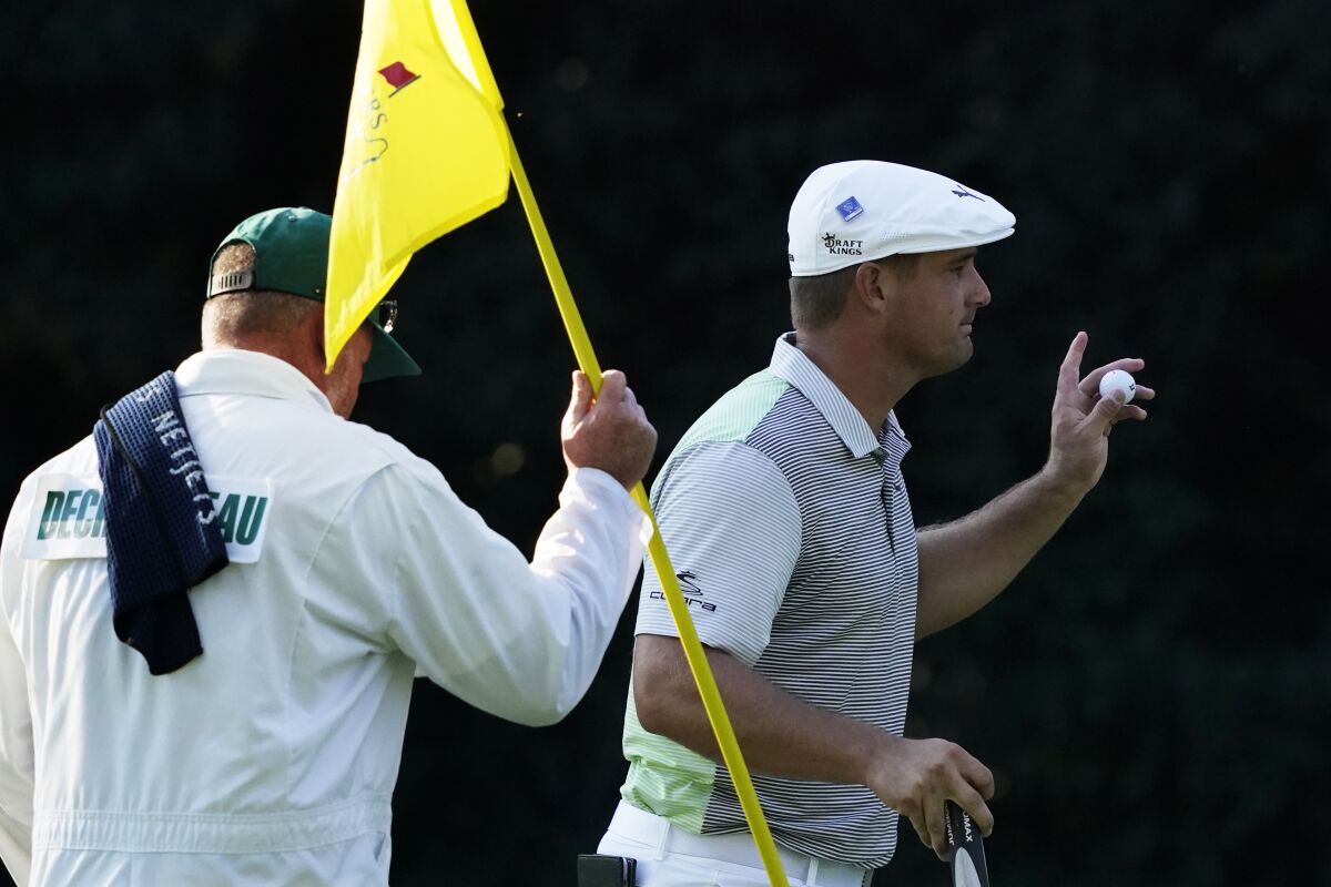 Bryson DeChambeau holds up his ball after a birdie on the sixth hole during the second round of the Masters.