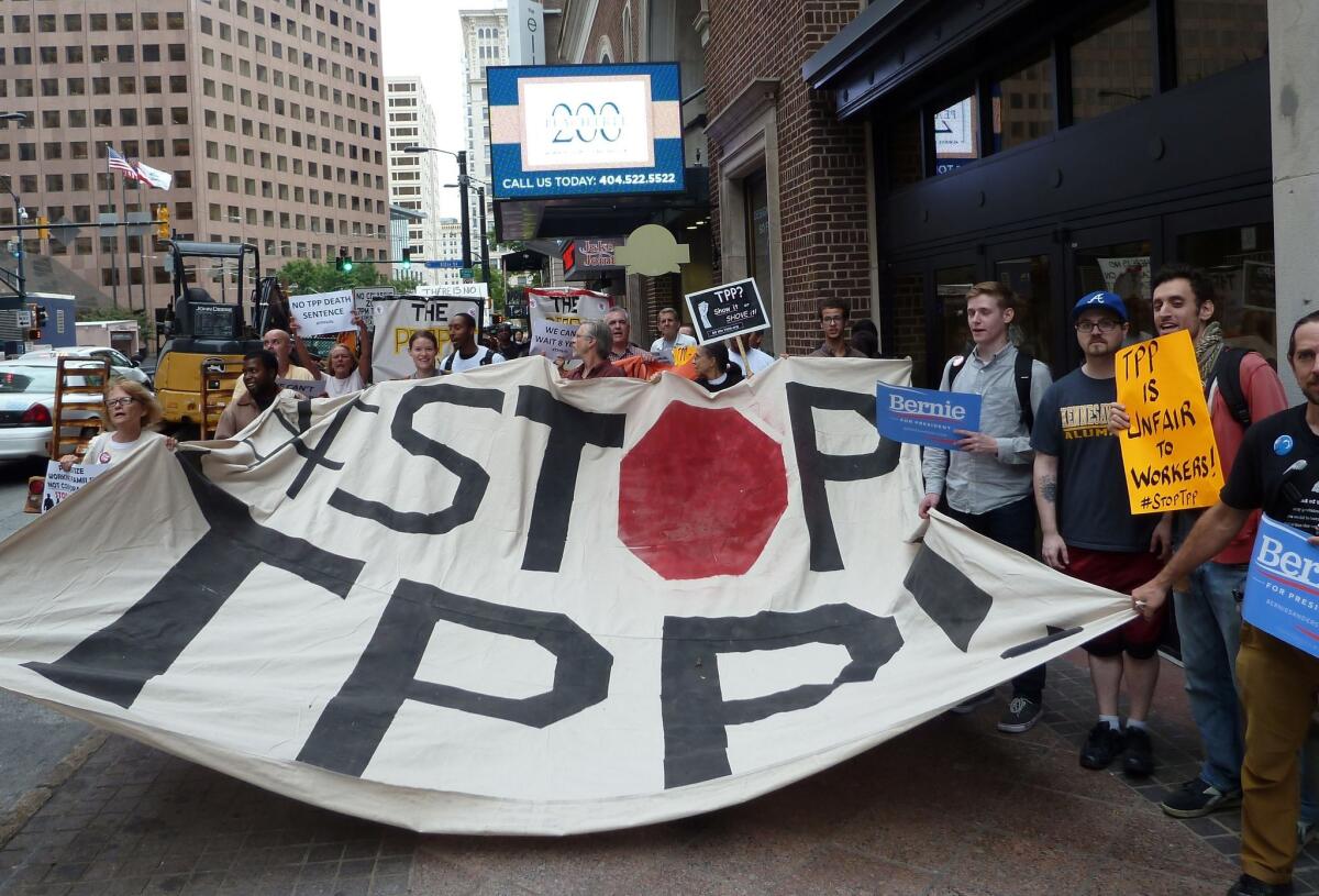 Protestors call for the rejection of the Trans-Pacific Partnership trade deal under negotiation in Atlanta on Thursday.