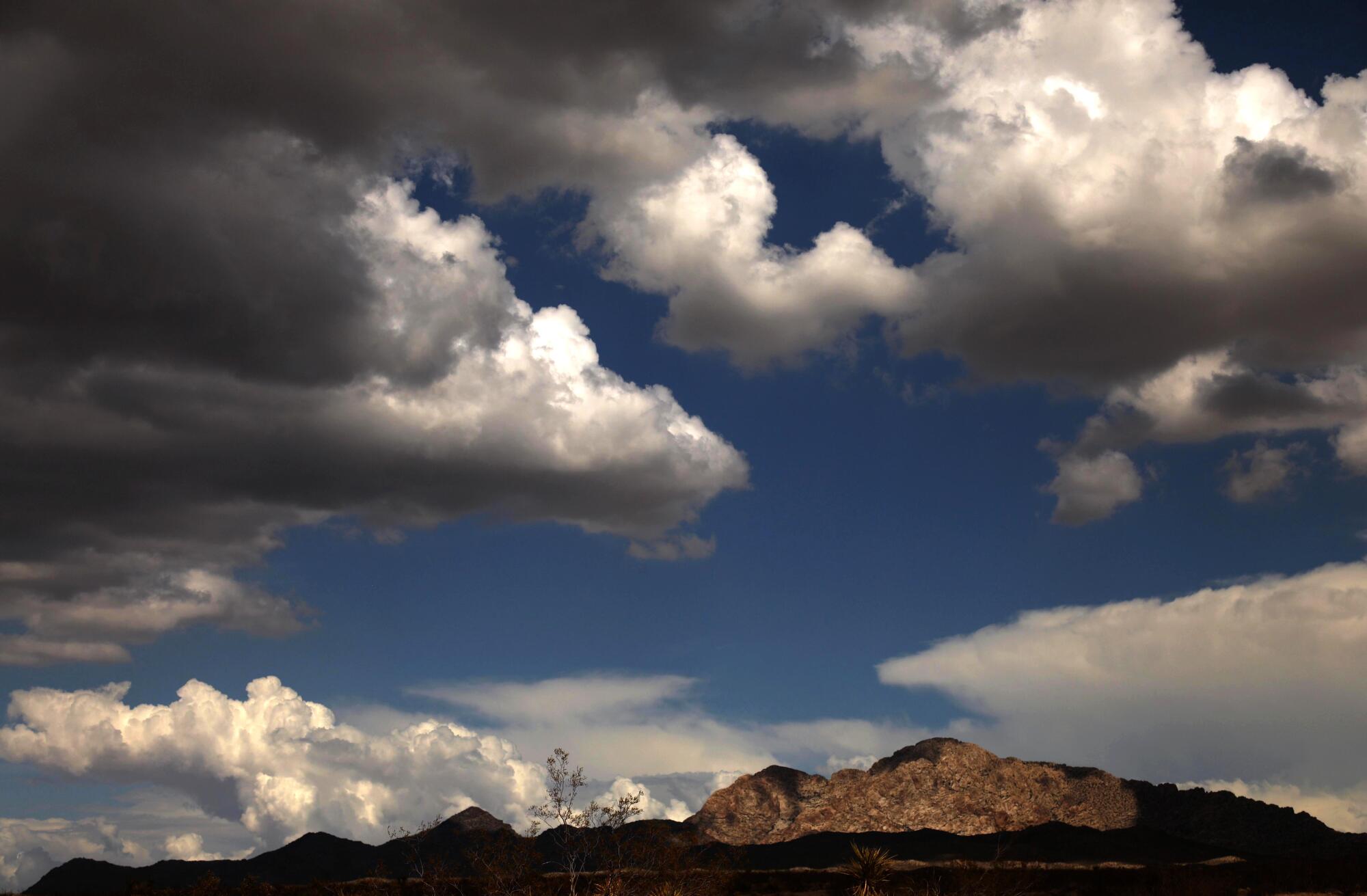 Clouds part to throw a spotlight on Avi Kwa' Ame or Spirit Mountain, within the Lake Mead National Recreation Area.