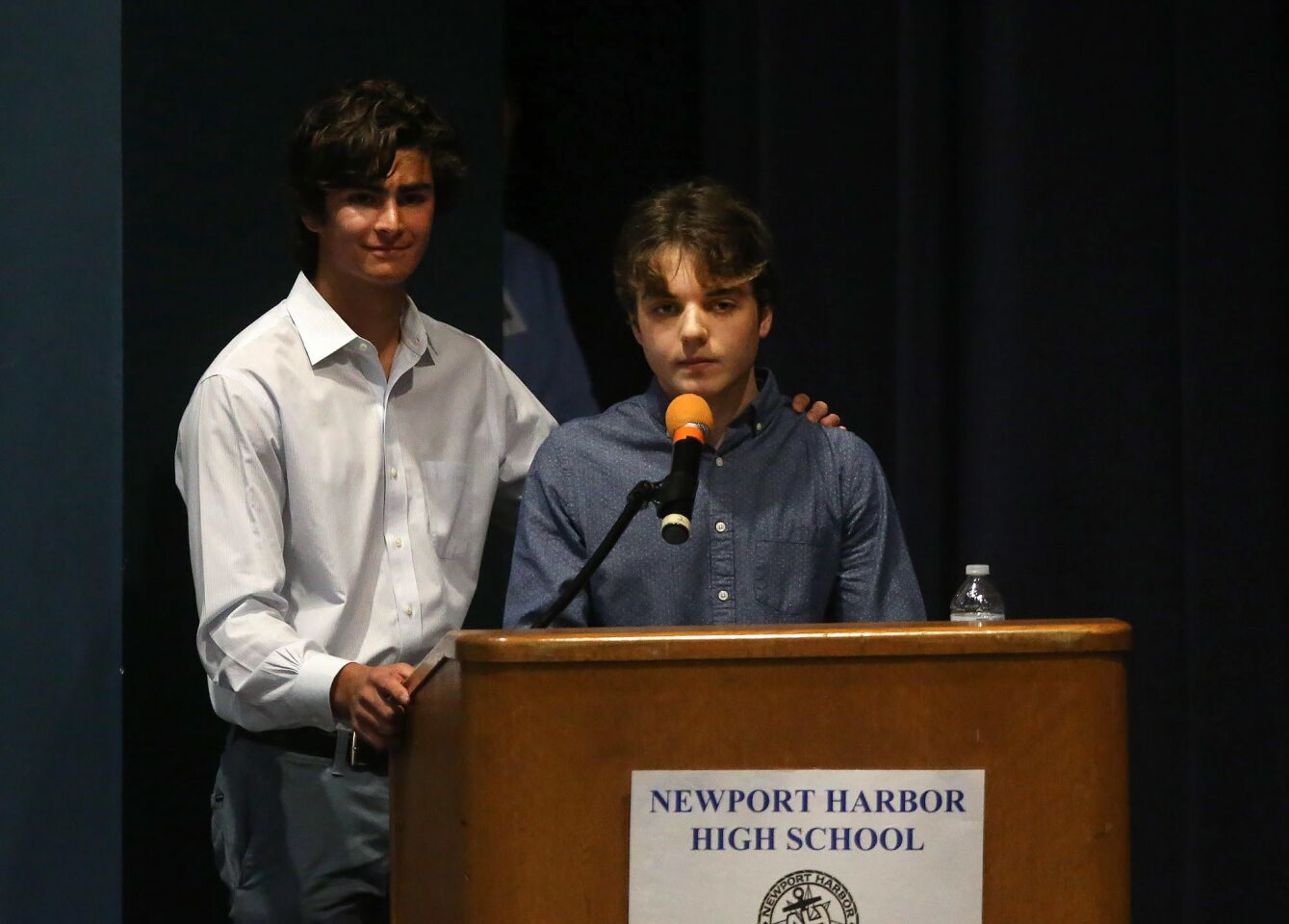 Newport Harbor High School seniors Ben Kwong, left, and Max Drakeford speak during Monday's community meeting at the school to address Nazi symbolism that some area students used during an off-campus party over the weekend. “What we need to focus on is educating people to the point that they aren’t ignorant enough to commit something like this,” Drakeford said.