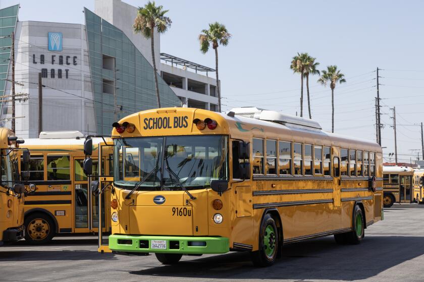 LOS ANGELES, CA - AUGUST 02: The Los Angeles Unified School District is looking to expand its electric bus fleet with its distinctive green bumpers and wheels. Superintendent Alberto M. Carvalho said that of the district's 1,300 buses, 67 percent run on alternative fuels like compressed natural gas, propane and electric. Photographed at LAUSD San Julian bus yard in Los Angeles, CA on Friday, Aug. 2, 2024. (Myung J. Chun / Los Angeles Times)