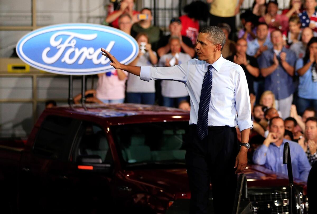 President Obama waves to the crowd after speaking to workers during a visit to the Ford Kansas City Stamping Plant in Liberty, Mo.