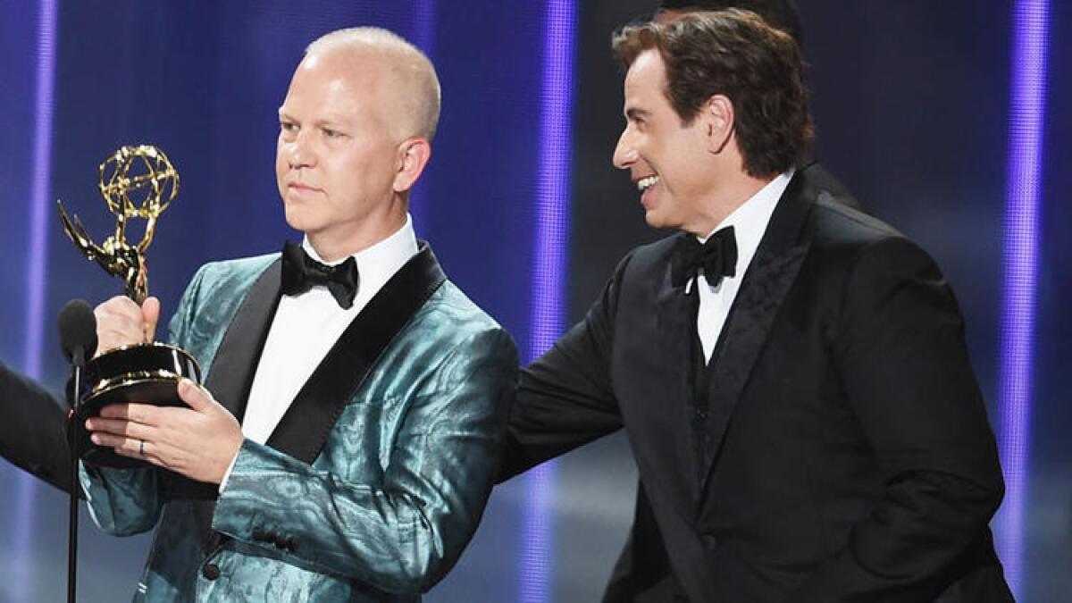 Ryan Murphy and John Travolta accept the Emmy for outstanding limited series for "The People v. O.J. Simpson."