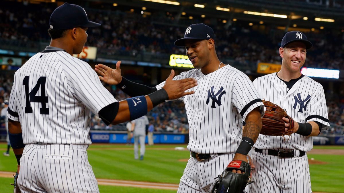 New York Yankees' Aaron Hicks (31) is met by teammates Starlin Castro (14) and Todd Frazier (29) after the first inning against the Tampa Bay Rays at Yankee Stadium on Tuesday.