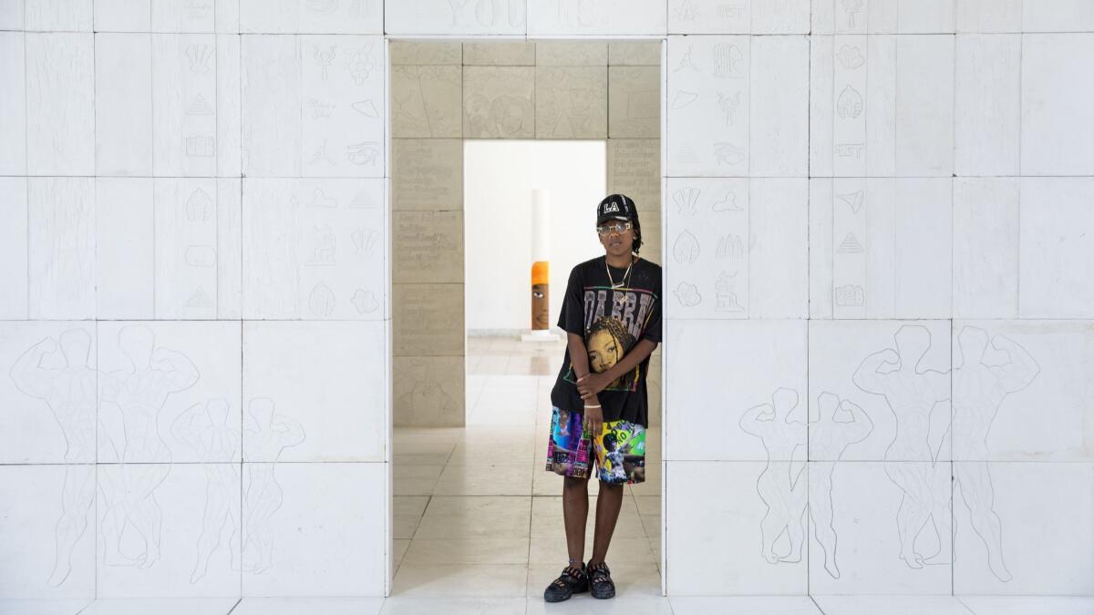 Lauren Halsey stands in the doorway of a monument prototype for South L.A. at the Hammer Museum.