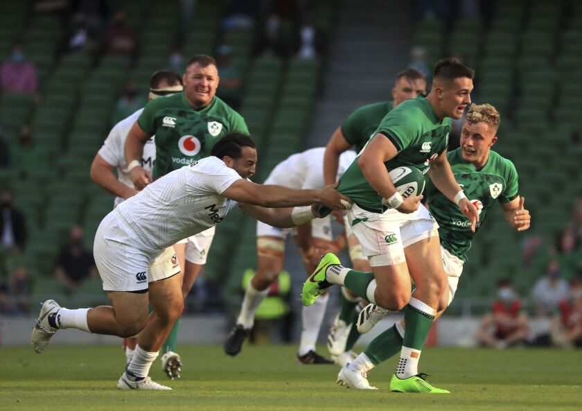Ireland's James Hume, right, is tackled by USA's Christian Dyer , during the Rugby Union International Summer Series match between Ireland and USA, in Dublin, Ireland, Saturday July 10, 2021. (Donall Farmer/PA via AP)