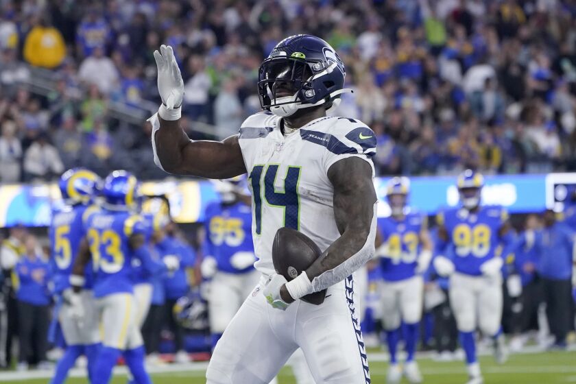 Seattle Seahawks wide receiver DK Metcalf celebrates after catching an 8-yard touchdown pass during the second half of an NFL football game against the Los Angeles Rams Sunday, Dec. 4, 2022, in Inglewood, Calif. (AP Photo/Marcio Jose Sanchez)