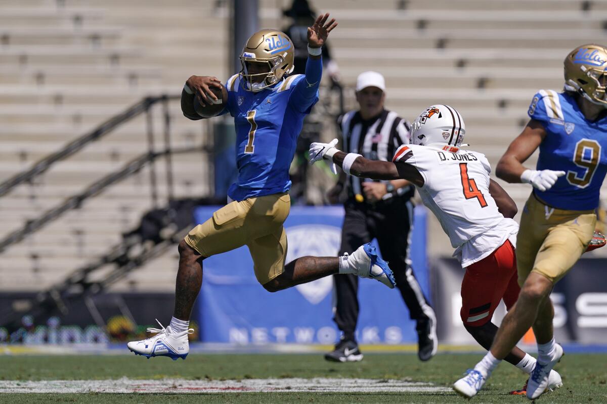 UCLA quarterback Dorian Thompson-Robinson avoids Bowling Green cornerback Deshawn Jones Jr.