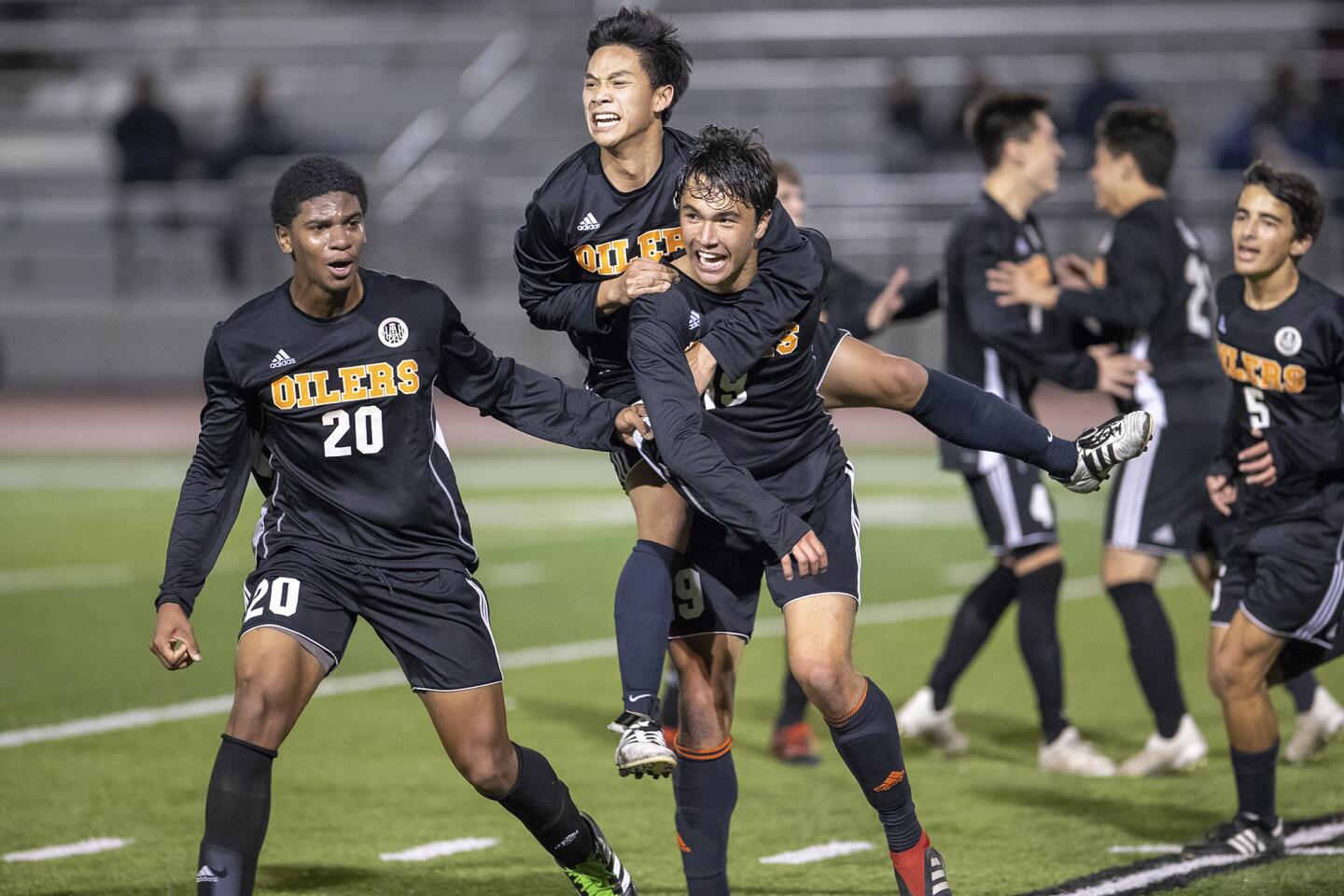 Huntington Beach High's Phillip Pham rides on the back of Brandon Francis after Francis scored the game-winning goal against Fountain Valley during a Wave League match at home Wednesday.