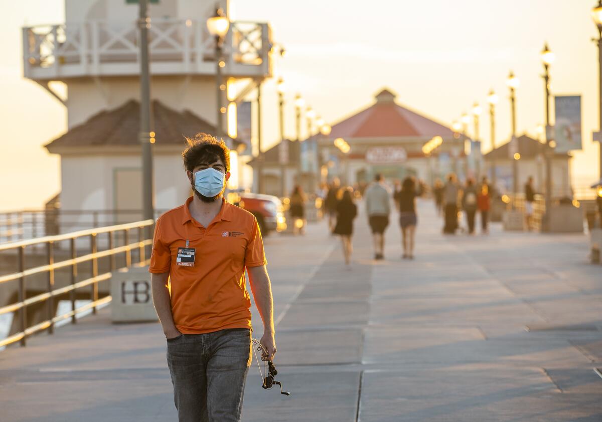 Julian Radmilovich, from Anaheim, walks along the Huntington Beach Pier.