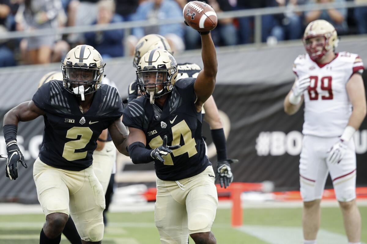 Purdue defensive back Antonio Blackmon (14) celebrates with teammates after intercepting a pass in the end zone against Boston College during the third quarter Saturday.