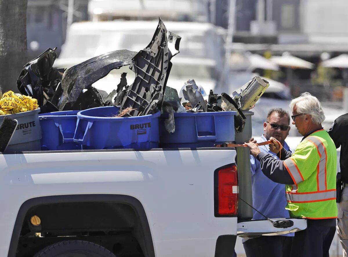 Wreckage from a Tesla Model S Plaid that slammed into construction equipment in Newport Beach May 12 is gathered by police.