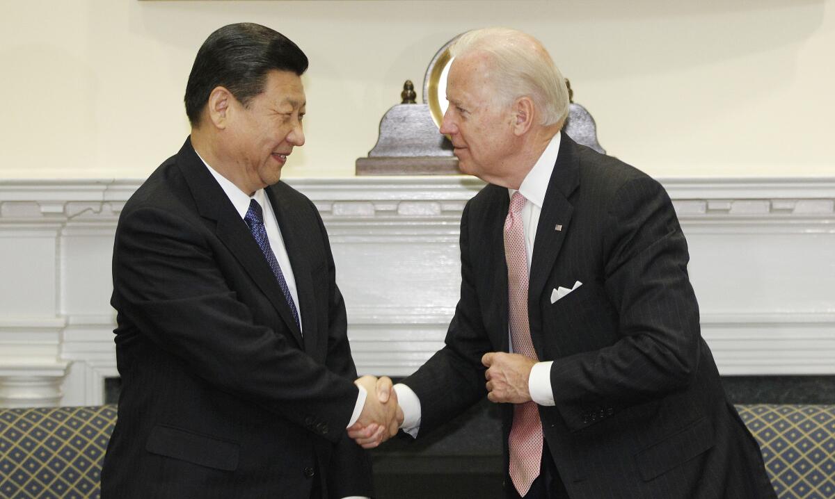 Joe Biden and China's Xi Jinping shake hands