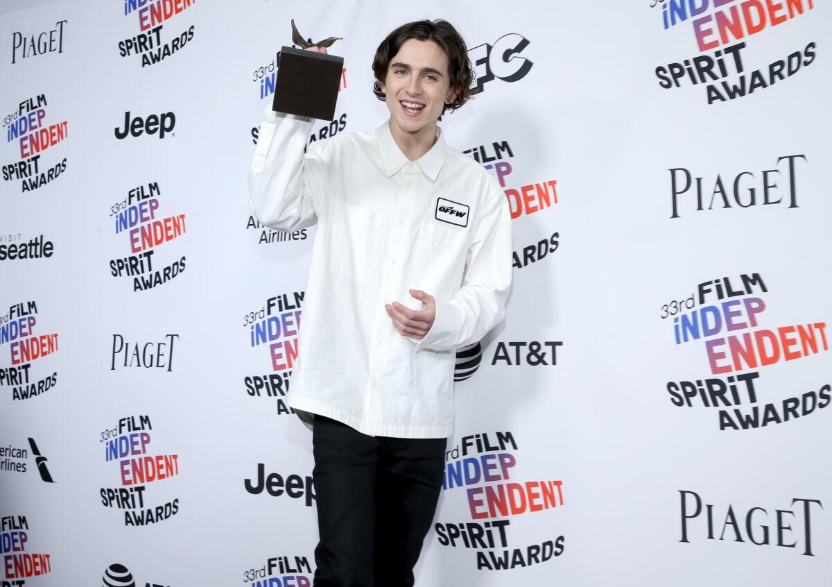 Timothée Chalamet poses with his best male lead statue at the Independent Spirit Awards in Santa Monica on Saturday. The "Call Me By Your Name" star wore an Off White c/o Virgil Abloh white utility shirt.