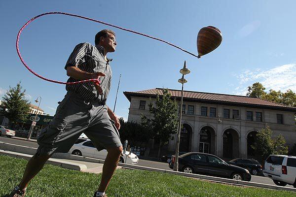 Alan Gray of Omaha spins a large top before judging the competition at the 2010 National Yo-Yo Contest in Chico, Calif. The Northern California college town is a magnet for the sport's elite. At this time each year, they arrive with new moves, new tricks, new attitude. See full story