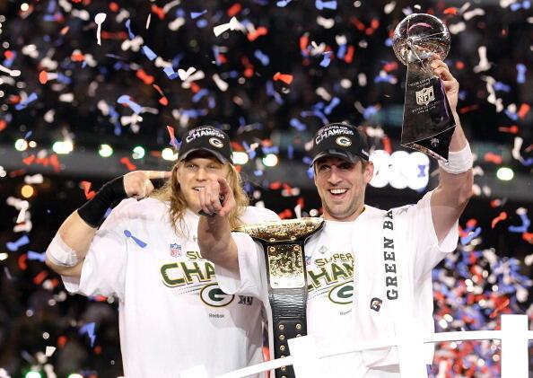 Super Bowl MVP Aaron Rodgers #12 of the Green Bay Packers holds up the Vince Lombardi Trophy as Clay Matthews #52 looks on after winning Super Bowl XLV 31-25 against the Pittsburgh Steelers at Cowboys Stadium on February 6, 2011 in Arlington, Texas.