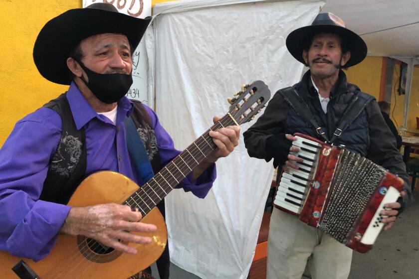 La música norteña suena en las voces y los instrumentos de Elías Flores y César Villanueva (derecha).