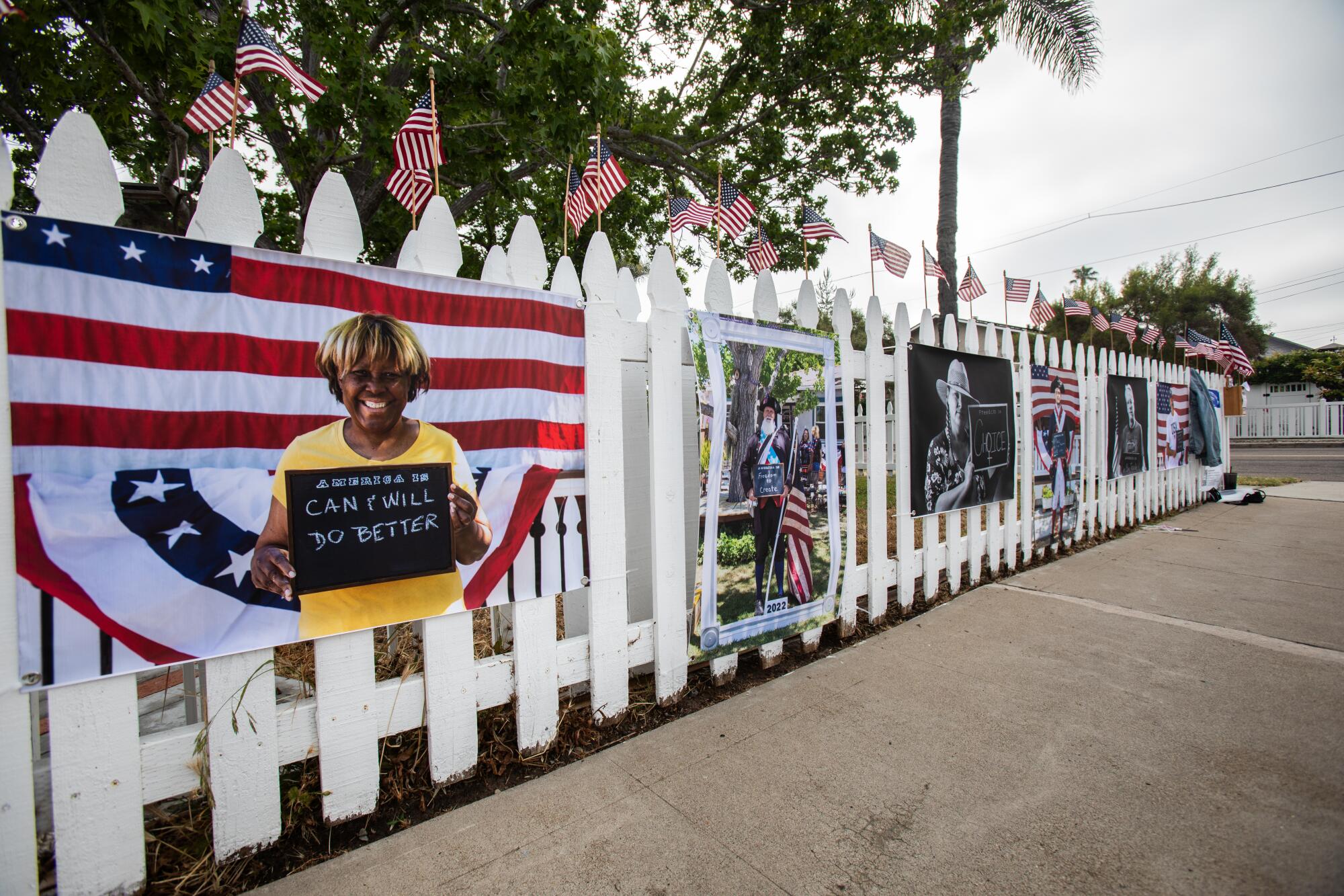 Portraits taken by Todd Bradley are displayed along a fence in Normal Heights San Diego, CA on Saturday, July 1, 2023. 