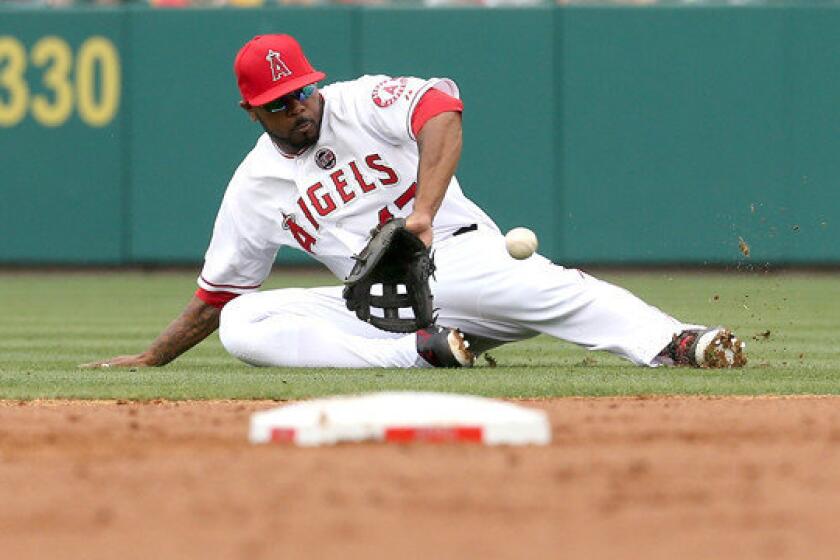 Angels second baseman Howie Kendrick tries to a field a ground ball during the second inning of the Angels' loss to the Oakland Athletics on Sunday.