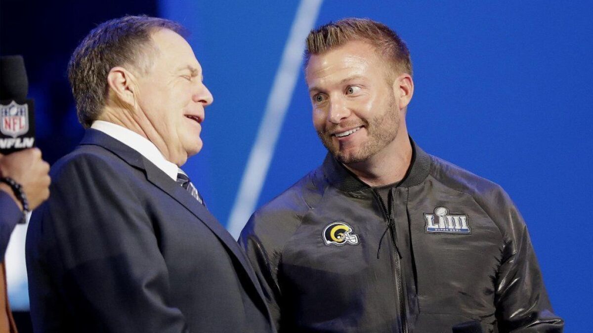 Patriots coach Bill Belichick, left, and Rams coach Sean McVay, right, talk at Super Bowl LIII opening night in Atlanta on Monday.