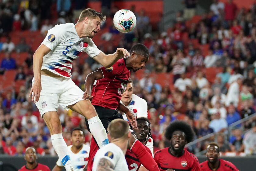 Walker Zimmerman, left, jumps for a header with Trinidad and Tobago's Kevan George during a CONCACAF Gold Cup game June 22 in Cleveland.