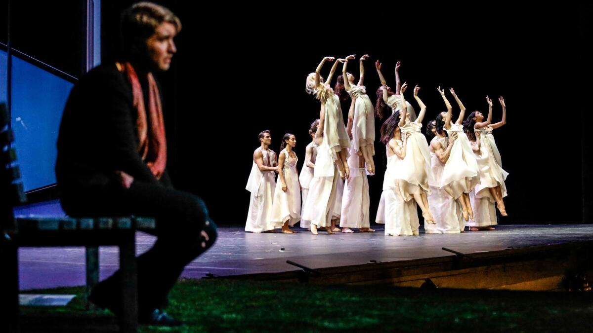 Tenor Maxim Mironov, as Orpheus, watches dancers from Joffrey Ballet portray the blessed spirits of the Elysian Fields in John Neumeier's production of Gluck's "Orpheus and Eurydice" for Los Angeles Opera.