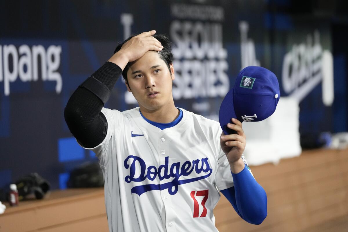 Shohei Ohtani prepares in the dugout for an exhibition game against Team Korea on Monday in Seoul.