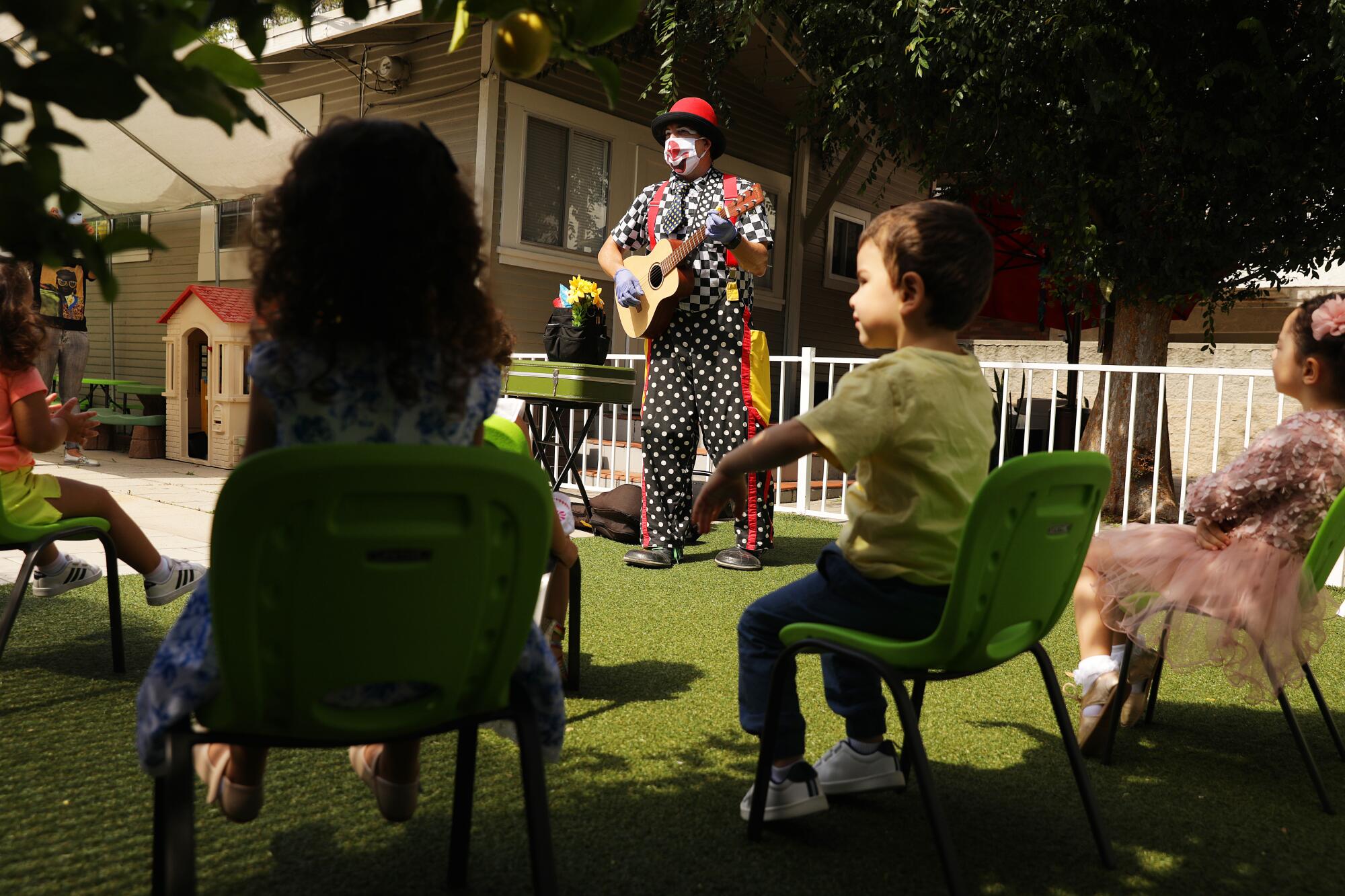 Guilford Adams performs a show for children at a preschool in Glendale.