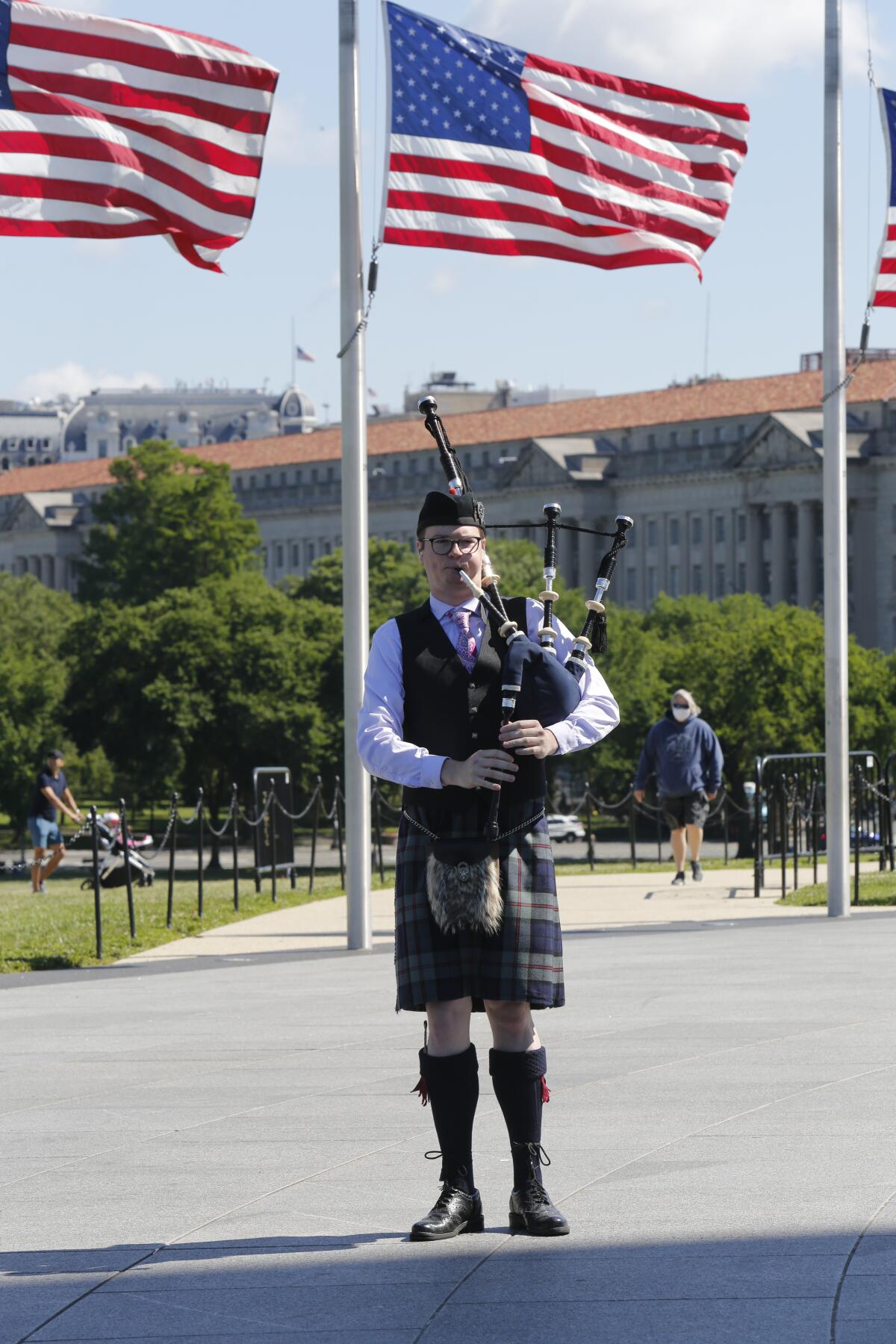 Bagpiper playing at the opening ceremony at the base of the Washington Monument.