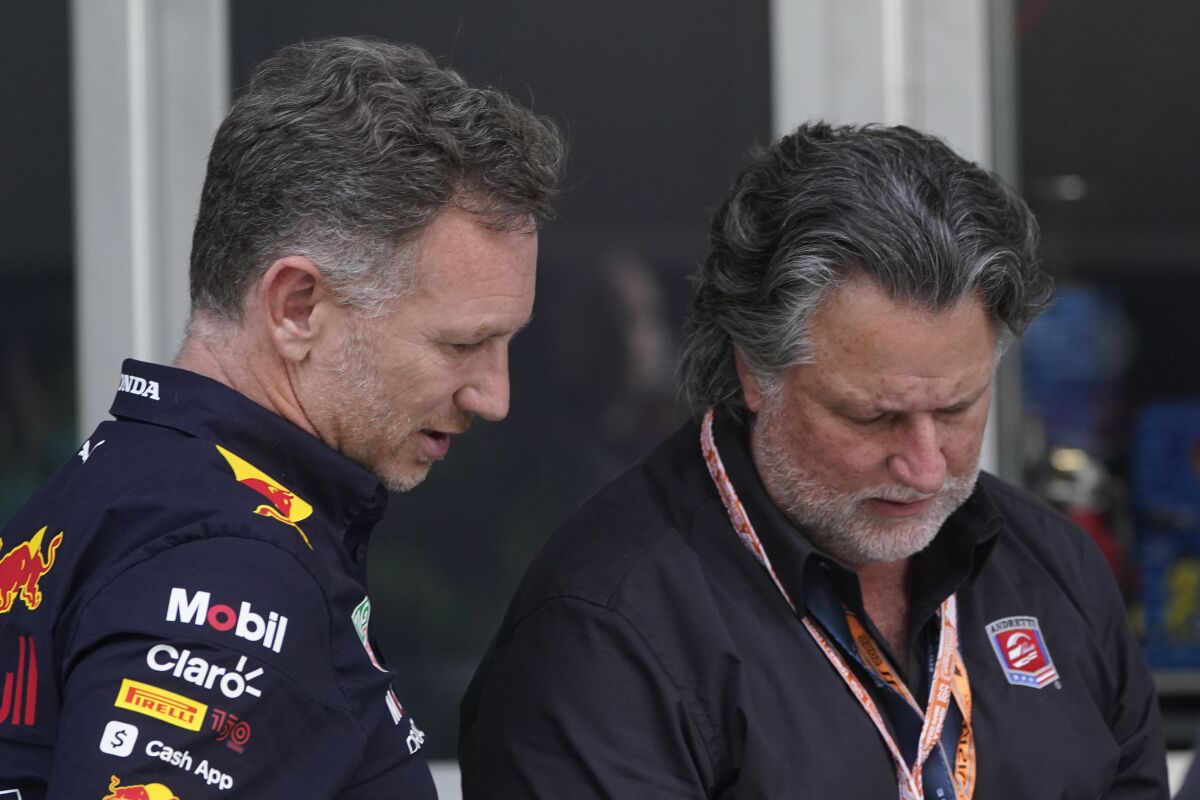 Red Bull Racing team principal Christian Horner, left, talks with Michael Andretti after the qualifying sessions for the Formula One Miami Grand Prix auto race at Miami International Autodrome, Saturday, May 7, 2022, in Miami Gardens, Fla. Andretti failed last year to buy an existing F1 team and has since applied for expansion to start a team. (AP Photo/Wilfredo Lee)